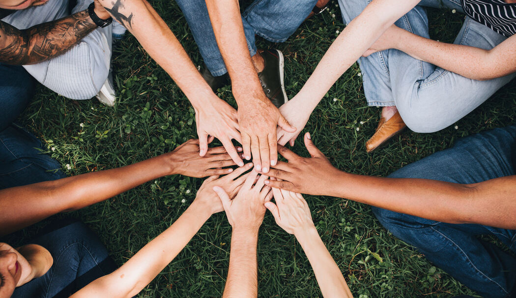 1228869_1_fullwidth_people-stacking-hands-together-in-the-park
